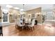 The dining room features hardwood floors, a modern chandelier, and large windows for natural light at 465 Monroe St, Denver, CO 80206