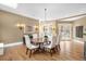 A dining room showcases hardwood floors, a modern chandelier, and access to a patio through elegant french doors at 465 Monroe St, Denver, CO 80206