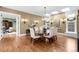This dining room features hardwood floors, a modern chandelier, and easy access to other living areas at 465 Monroe St, Denver, CO 80206