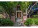 Beautiful brick home with mature landscaping, elegant architectural details and a stone path at 465 Monroe St, Denver, CO 80206