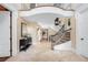 Bright and airy foyer with an elegant staircase and travertine floors creates a welcoming entrance at 465 Monroe St, Denver, CO 80206