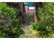 Iron gate surrounded by beautiful landscaping and flowers leads to a private garden area at 465 Monroe St, Denver, CO 80206