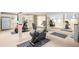 Home gym featuring various exercise equipment, mirrors, and neutral flooring at 465 Monroe St, Denver, CO 80206