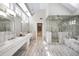 Main bathroom features a double vanity, glass-enclosed shower, and tiled flooring at 465 Monroe St, Denver, CO 80206