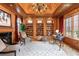 Wood-paneled office featuring built-in bookshelves, fireplace, and natural light provides a workspace at 465 Monroe St, Denver, CO 80206