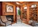 Wood-paneled office featuring built-in bookshelves, fireplace, and natural light provides a workspace at 465 Monroe St, Denver, CO 80206