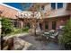 Relaxing outdoor patio featuring garden, stone and brick architecture, and an outdoor dining area at 465 Monroe St, Denver, CO 80206
