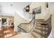 Elegant staircase with decorative wrought iron, carpet runner, and high ceilings fills the space at 465 Monroe St, Denver, CO 80206