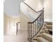 Elegant staircase with decorative iron railings and carpeted steps, leading to the upper level at 465 Monroe St, Denver, CO 80206