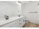 Bathroom with double sink vanity, white countertops and cabinets and black hardware at 7036 E 126Th Pl, Thornton, CO 80602