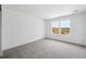 Bright bedroom with carpet, white walls, and a double window overlooking the construction of future homes at 7036 E 126Th Pl, Thornton, CO 80602