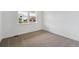 Bright bedroom featuring plush carpeting, neutral walls and a window with a view of the outdoors at 7036 E 126Th Pl, Thornton, CO 80602