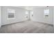 Bedroom featuring neutral carpeting and several windows overlooking the neighborhood at 7036 E 126Th Pl, Thornton, CO 80602