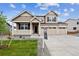 Charming two-story home with landscaped yard, a welcoming porch, and a three-car garage at 7036 E 126Th Pl, Thornton, CO 80602
