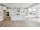 Spacious kitchen features white cabinets, stainless steel appliances, and an island with room for seating at 7036 E 126Th Pl, Thornton, CO 80602