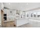 Bright kitchen features white cabinets, stainless steel appliances, and an island with breakfast bar seating at 7036 E 126Th Pl, Thornton, CO 80602