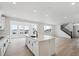 Open-concept kitchen with island, stainless steel appliances and adjacent living and dining areas at 7036 E 126Th Pl, Thornton, CO 80602