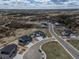 Beautiful aerial view of a new neighborhood in a lovely setting with mature trees and rolling hills at 3226 Wingspan Pt, Castle Rock, CO 80108