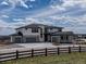 Beautiful modern home featuring stone accents, large windows, and a spacious three car driveway at 3226 Wingspan Pt, Castle Rock, CO 80108