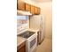 Well-equipped kitchen with stove, refrigerator, and wood cabinetry at 1261 S Gilbert St # 202, Castle Rock, CO 80104