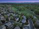Wide aerial view of a residential neighborhood with green spaces, walking paths, and mountain views in the background at 4347 W Kenyon Ave, Denver, CO 80236