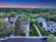 Aerial view of a home with solar panels, manicured lawn, and a paved walkway next to a greenbelt with mountain views at 4347 W Kenyon Ave, Denver, CO 80236