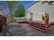 Backyard with multi-tiered patio, fire pit area, and yard for outdoor enjoyment at 4347 W Kenyon Ave, Denver, CO 80236