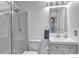 Modern bathroom features a glass enclosed shower, vanity, and stylish fixtures at 4347 W Kenyon Ave, Denver, CO 80236