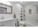 Updated bathroom with white subway tiles, a new vanity, and modern fixtures at 4347 W Kenyon Ave, Denver, CO 80236