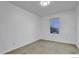 Carpeted bedroom features neutral walls and a window for natural light at 4347 W Kenyon Ave, Denver, CO 80236