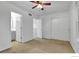 Bright bedroom with closet, ceiling fan, and adjacent bathroom for convenience at 4347 W Kenyon Ave, Denver, CO 80236