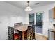 Cozy dining area with a wooden table, chairs, and sliding glass doors leading to the backyard at 4347 W Kenyon Ave, Denver, CO 80236