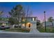 Charming two-story home with a one car garage, manicured lawn, and lovely dusk sky backdrop at 4347 W Kenyon Ave, Denver, CO 80236