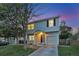 Charming two-story home with a one car garage, manicured lawn, and lovely dusk sky backdrop at 4347 W Kenyon Ave, Denver, CO 80236