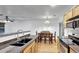 Bright kitchen seamlessly connects to the dining area, offering stainless steel appliances and ample counter space at 4347 W Kenyon Ave, Denver, CO 80236