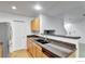 Modern kitchen featuring wooden cabinets, granite countertops, and an eat-in bar area at 4347 W Kenyon Ave, Denver, CO 80236