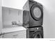 Convenient laundry area with modern black appliances, countertop and shelf at 4347 W Kenyon Ave, Denver, CO 80236