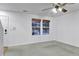 Spacious living room with ample natural light and a ceiling fan, providing a comfortable and inviting atmosphere at 4347 W Kenyon Ave, Denver, CO 80236
