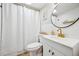 Bright and crisp bathroom with gold hardware and white tiling at 1020 15Th St # 35N, Denver, CO 80202