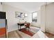 Bedroom with a desk, chair and vibrant artwork accentuating the natural light from the large window at 1020 15Th St # 35N, Denver, CO 80202