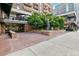 Building entrance with inviting plaza, featuring a statue and lush greenery at 1020 15Th St # 35N, Denver, CO 80202
