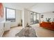 Bright, open living room leading to a balcony with city and mountain views at 1020 15Th St # 35N, Denver, CO 80202