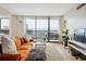 Inviting living room with a comfortable seating area and a view of the balcony with mountain views at 1020 15Th St # 35N, Denver, CO 80202