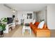 Comfortable living room showcasing an eye-catching orange couch with decor throughout at 1020 15Th St # 35N, Denver, CO 80202