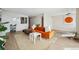 Inviting open-concept living area with stylish decor, with an inviting orange sofa, rug and decor at 1020 15Th St # 35N, Denver, CO 80202