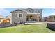 Spacious backyard featuring a well-manicured lawn, patio, and a view of the home's rear exterior at 4009 Manorbrier Cir, Castle Rock, CO 80104