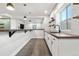 Basement bar area with modern white cabinets, wood counters, and stylish pendant lighting at 4009 Manorbrier Cir, Castle Rock, CO 80104