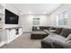 Cozy basement with a large sectional sofa and a built-in entertainment center at 4009 Manorbrier Cir, Castle Rock, CO 80104