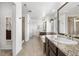 Bright and spacious bathroom featuring granite countertops, dual sinks, a soaking tub, and a walk-in shower at 4009 Manorbrier Cir, Castle Rock, CO 80104