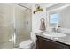 Bright bathroom featuring a glass shower enclosure, granite countertops, and neutral color palette at 4009 Manorbrier Cir, Castle Rock, CO 80104